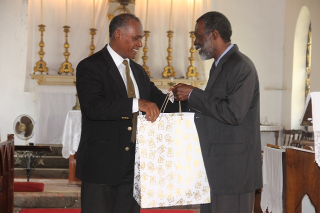 Premier of Nevis Hon. Vance Amory (left) presents Organisation of American States outgoing Ambassador to St. Kitts and Nevis His Excellency Starret Greene with a token of appreciation on behalf of the Government and people of Nevis at a special church service held in his honour at the St. Paul’s Anglican Church in Charlestown on June 18, 2014